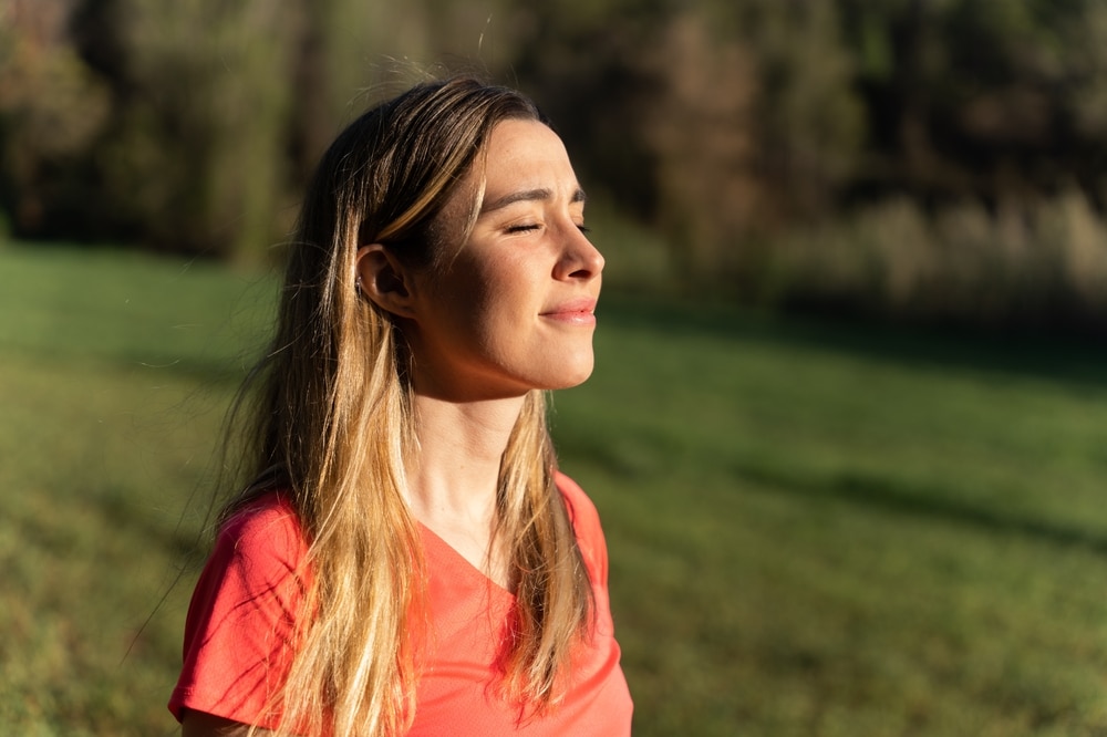Portrait,Of,A,Young,Woman,Smiling,In,Nature,Breathing,Air